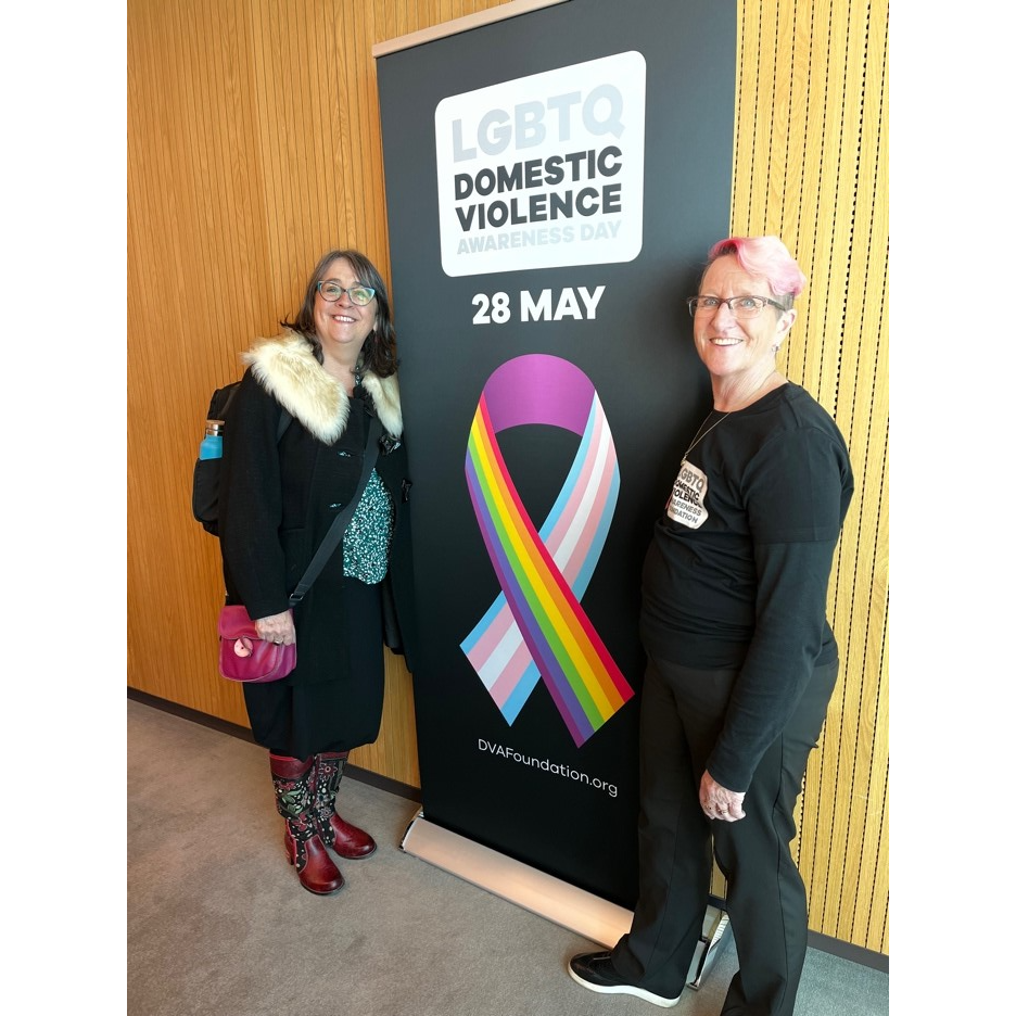 Two women in front of pull-up banner